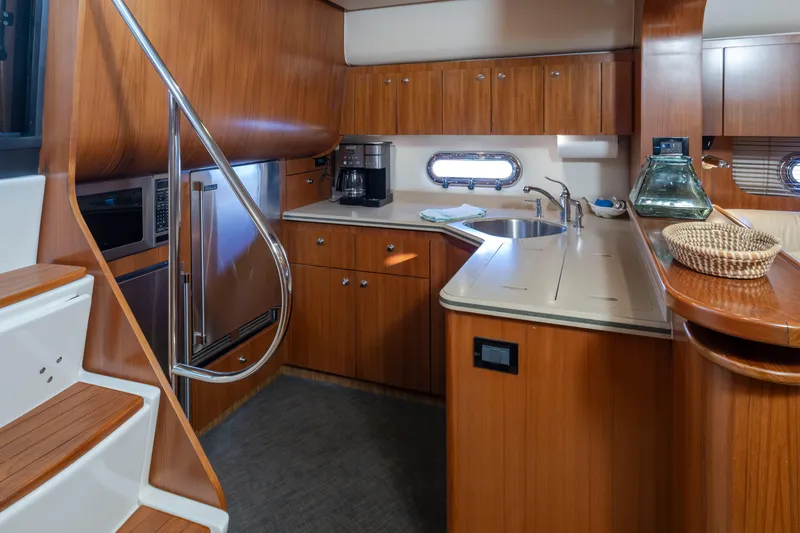 Slide: The Image of Luxurious 2005 Tiara Yachts 5200 Sovran Salon kitchen with wood cabinetry and modern appliances. - 37