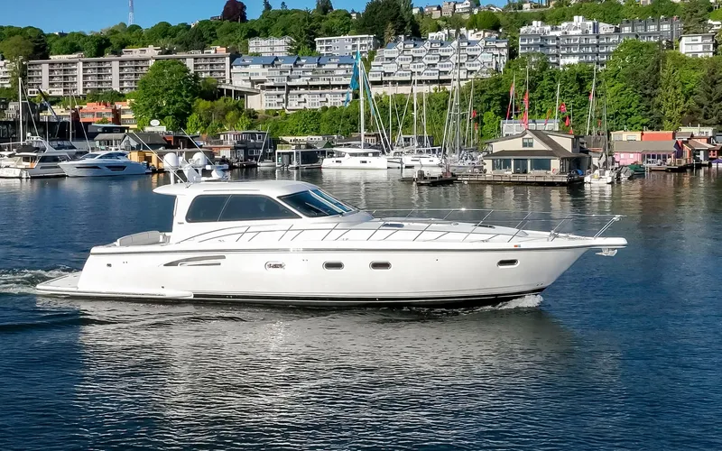 Slide: The Image of 2005 Tiara Yachts 5200 Sovran Salon cruising in a scenic marina setting. - 4