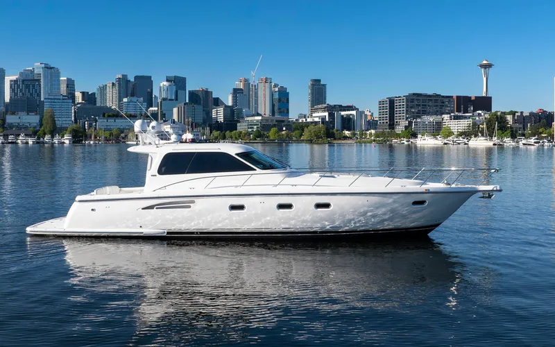 Slide: The Image of 2005 Tiara Yachts 5200 Sovran Salon on water with city skyline background. - 5