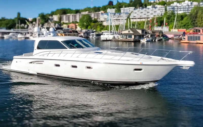 Slide: The Image of 2005 Tiara Yachts 5200 Sovran Salon cruising on a scenic waterfront. - 6