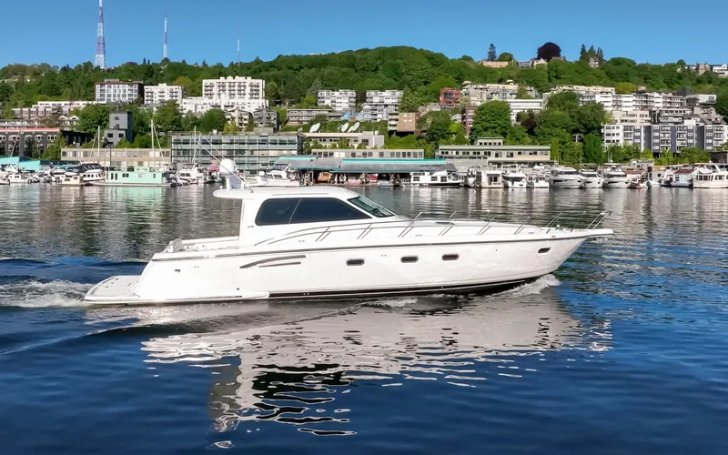 Slide: The Image of 2005 Tiara Yachts 5200 Sovran Salon cruising on a scenic waterfront. - 9