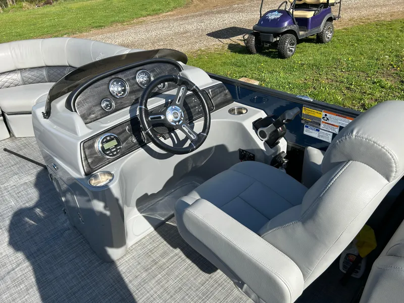 Slide: The Image of 2019 Misty Harbor Biscayne Bay 2285BR Triple Tube boat interior with steering console and seating. - 14