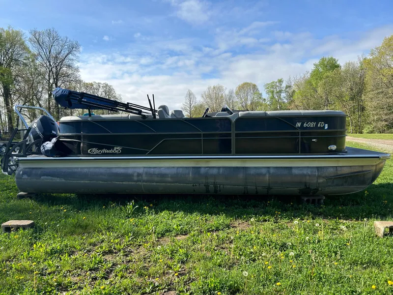 Slide: The Image of 2019 Misty Harbor Biscayne Bay 2285BR Triple Tube pontoon boat on grassy field. - 4