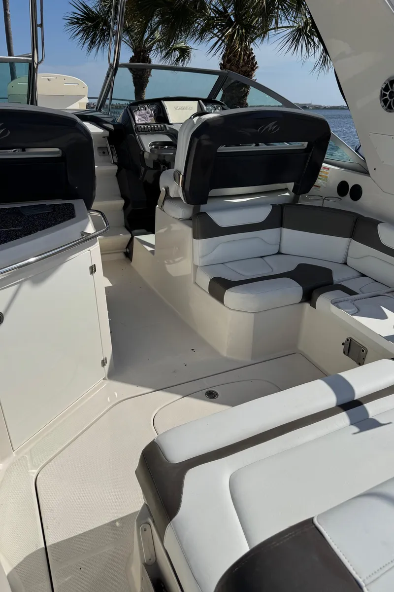 Slide: The Image of 2013 Monterey 320 Sport Yacht interior with sleek seating and modern dashboard. - 11