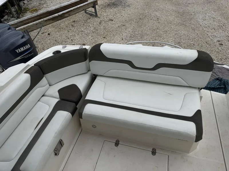 Slide: The Image of 2013 Monterey 320 Sport Yacht interior seating with white and gray upholstery. - 12