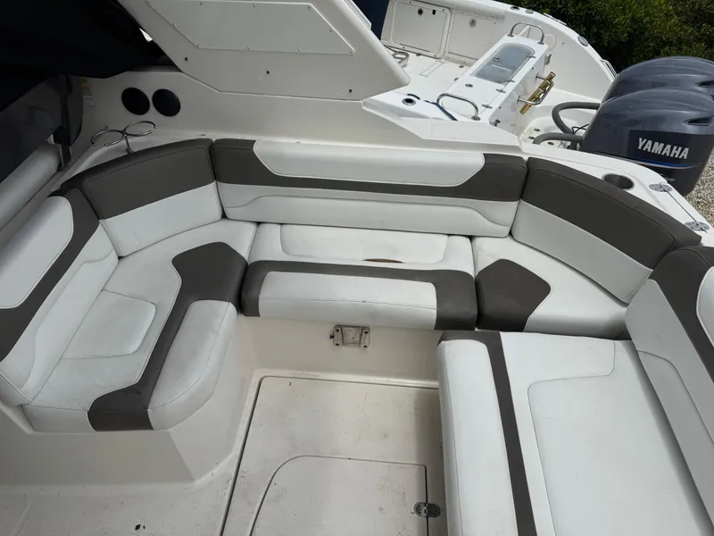 Slide: The Image of 2013 Monterey 320 Sport Yacht interior with white and gray seating, Yamaha engines visible. - 13