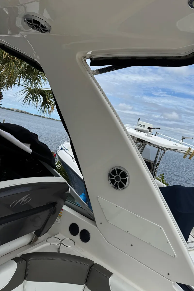 Slide: The Image of 2013 Monterey 320 Sport Yacht interior with speaker, overlooking water and boats. - 14