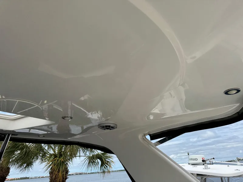 Slide: The Image of 2013 Monterey 320 Sport Yacht ceiling with palm trees and sky in the background. - 23
