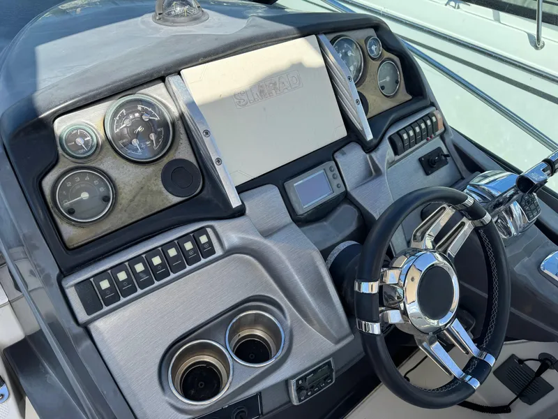 Slide: The Image of Dashboard of a 2013 Monterey 320 Sport Yacht with steering wheel and gauges. - 25