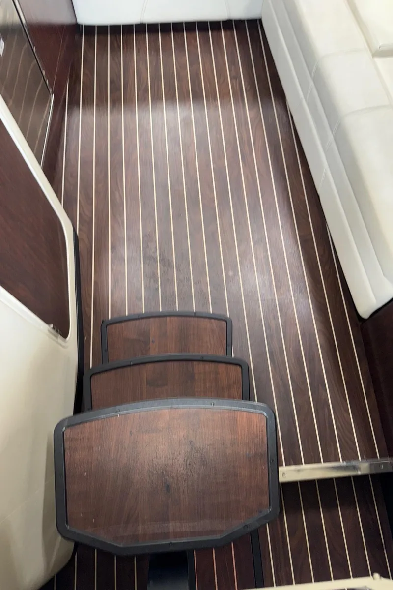 Slide: The Image of 2013 Monterey 320 Sport Yacht interior with wooden flooring and white seating. - 31