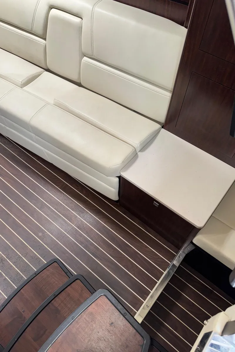 Slide: The Image of Interior of 2013 Monterey 320 Sport Yacht with beige seating and wooden flooring. - 33