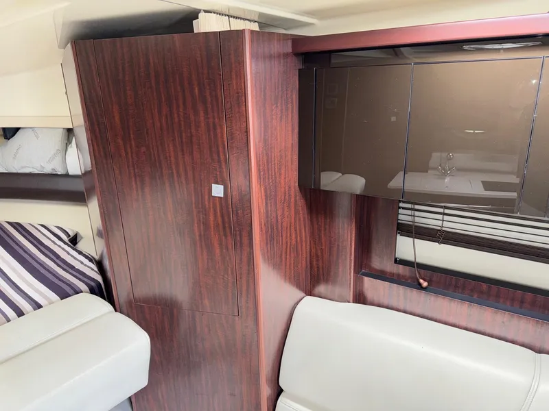 Slide: The Image of 2013 Monterey 320 Sport Yacht interior with wood paneling and modern seating. - 38