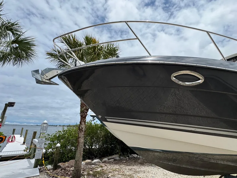 Slide: The Image of 2013 Monterey 320 Sport Yacht docked near palm trees and waterfront. - 4
