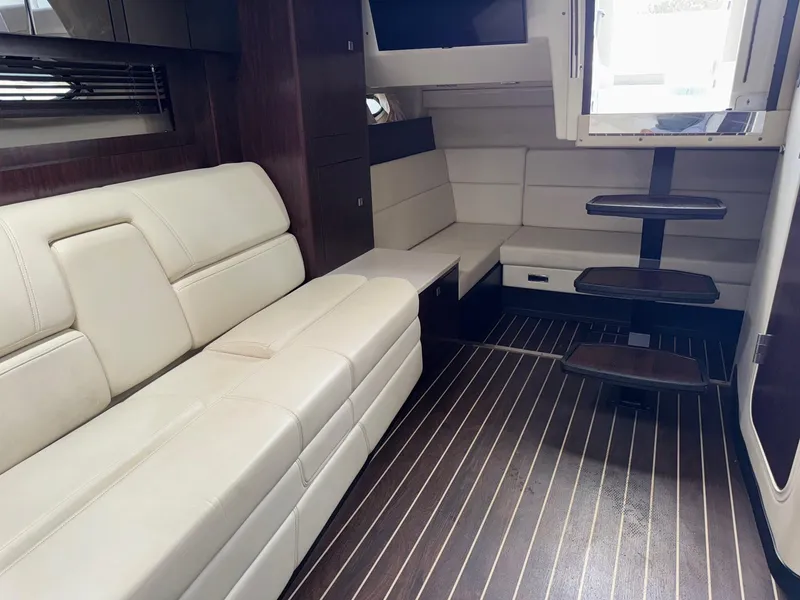 Slide: The Image of Interior of 2013 Monterey 320 Sport Yacht with beige seating and wooden flooring. - 42