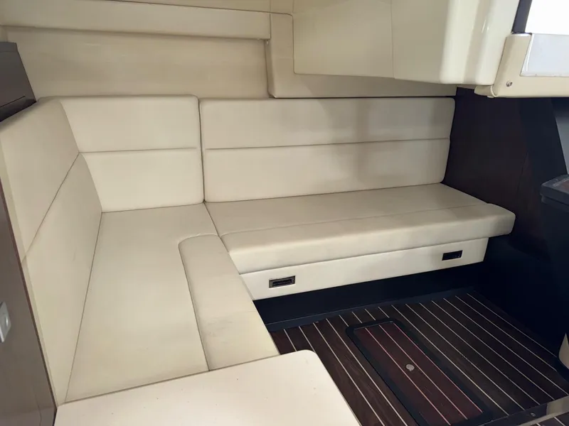 Slide: The Image of Interior of 2013 Monterey 320 Sport Yacht with beige seating and wooden flooring. - 45