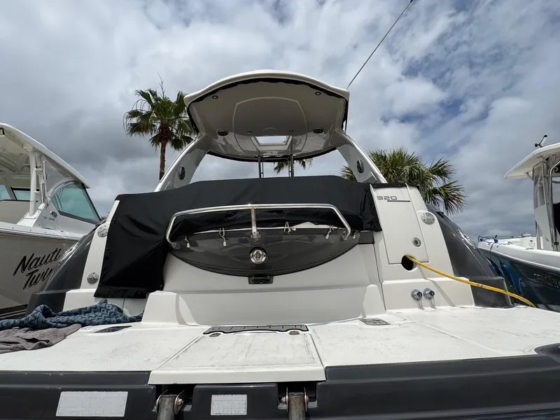 Slide: The Image of 2013 Monterey 320 Sport Yacht docked under cloudy sky with palm trees. - 7