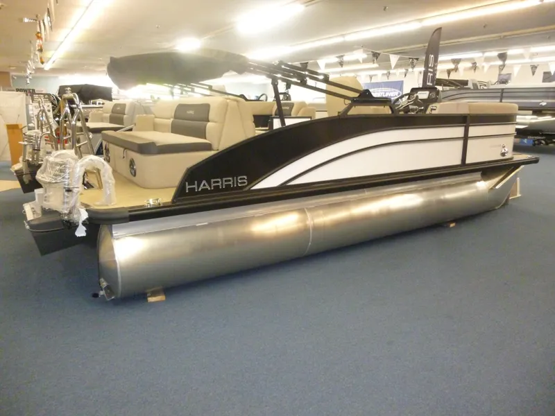 Slide: The Image of 2024 Harris CX210 pontoon boat displayed indoors with seating and canopy. - 9