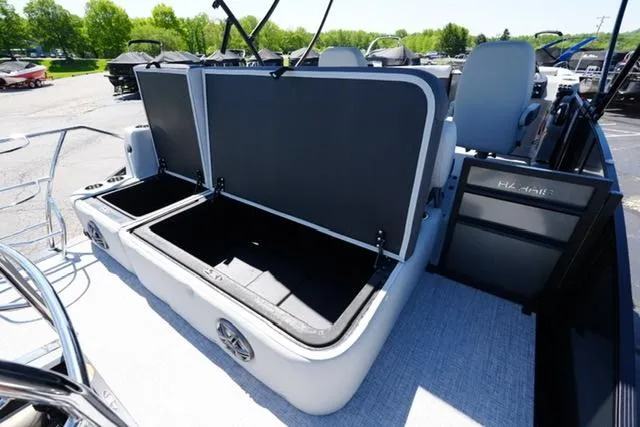 Slide: The Image of 2025 Harris Cruiser 210 boat with open storage compartments, showcasing spacious interior design. - 17