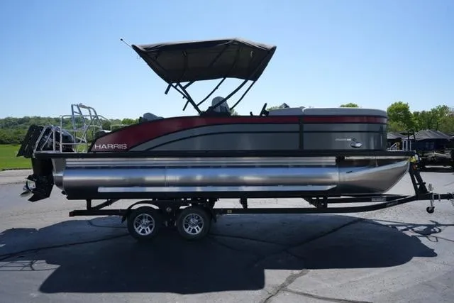 Slide: The Image of 2025 Harris Cruiser 210 pontoon boat on trailer, featuring sleek design and canopy. - 3