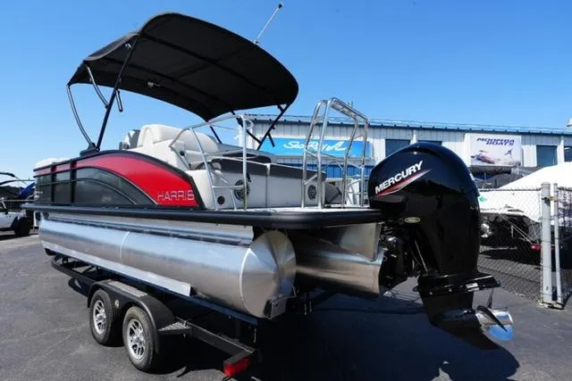 Slide: The Image of 2025 Harris Cruiser 210 pontoon boat with Mercury engine on a trailer. - 5