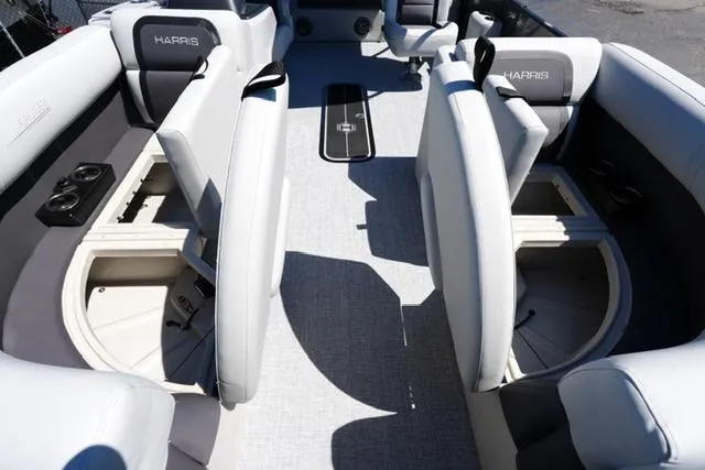 Slide: The Image of 2025 Harris Cruiser 210 interior with gray seating and storage compartments. - 9