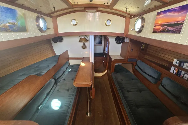 Slide: The Image of Interior of 1994 Bristol Channel Cutter Sam L Morse BCC 28, featuring cozy wooden furnishings. - 20