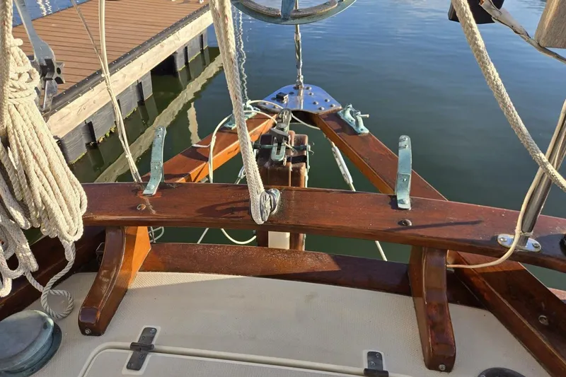 Slide: The Image of Bristol Channel Cutter 1994 sailboat deck with wooden fittings and ropes at dock. - 12