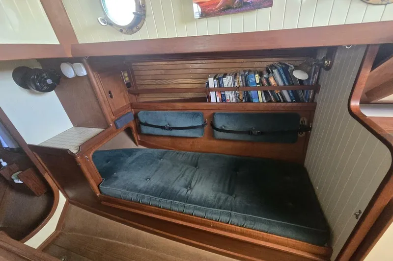 Slide: The Image of Cozy cabin interior of 1994 Bristol Channel Cutter Sam L Morse BCC 28 with bookshelf. - 22