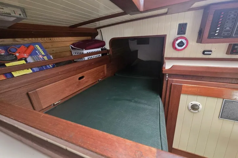 Slide: The Image of Interior of 1994 Bristol Channel Cutter Sam L Morse BCC 28, featuring wood paneling and storage. - 23