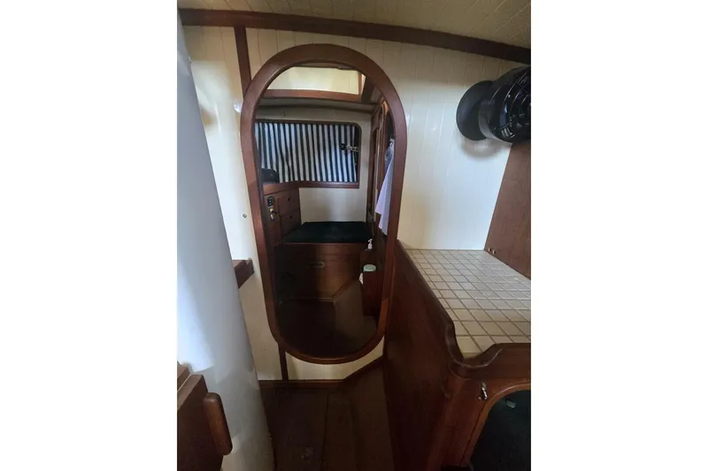 Slide: The Image of Interior of 1994 Bristol Channel Cutter Sam L Morse BCC 28, featuring wood finish and compact design. - 26