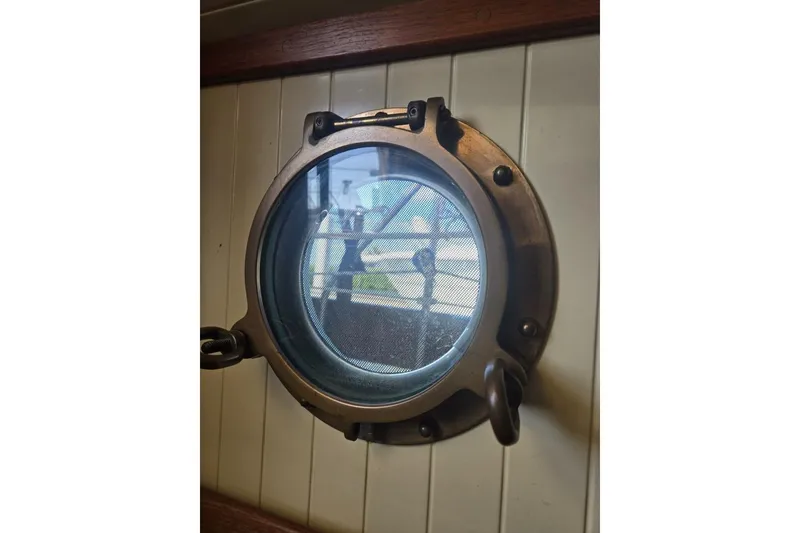 Slide: The Image of Porthole view from 1994 Bristol Channel Cutter Sam L Morse BCC 28 sailboat interior. - 31