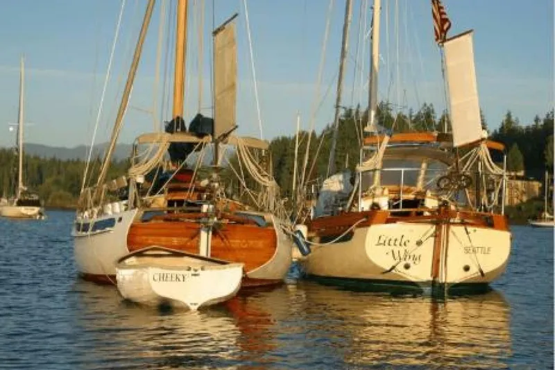 Slide: The Image of 1994 Bristol Channel Cutter Sam L Morse BCC 28 sailboats moored on calm water. - 32