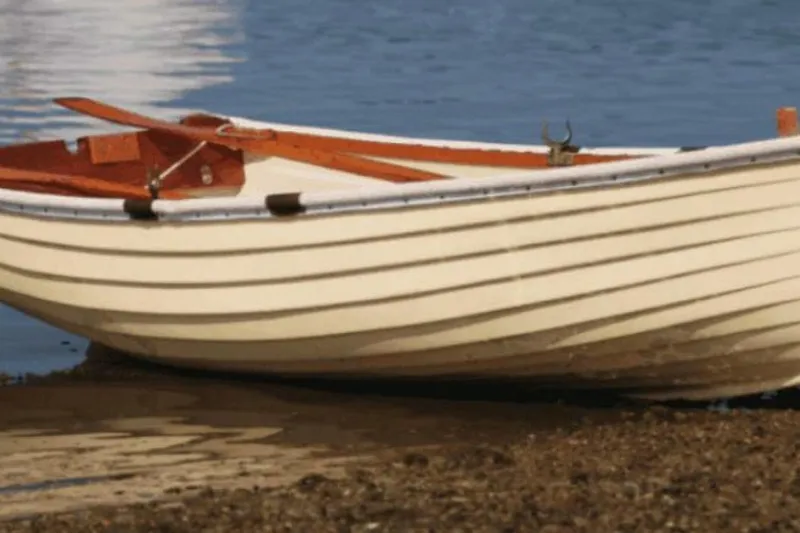 Slide: The Image of Classic 1994 Bristol Channel Cutter Sam L Morse BCC 28 on shore, wooden oars visible. - 33
