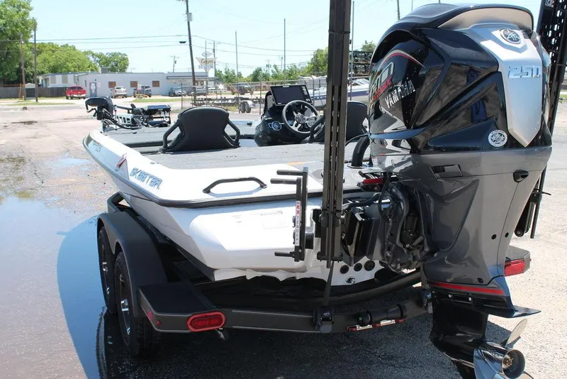 Slide: The Image of 2025 Skeeter ZXR21 boat with Yamaha engine on a trailer in a parking lot. - 5