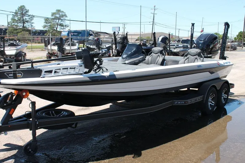 Slide: The Image of 2025 Skeeter ZXR21 boat on trailer, parked outdoors, showcasing sleek design and modern features. - 6