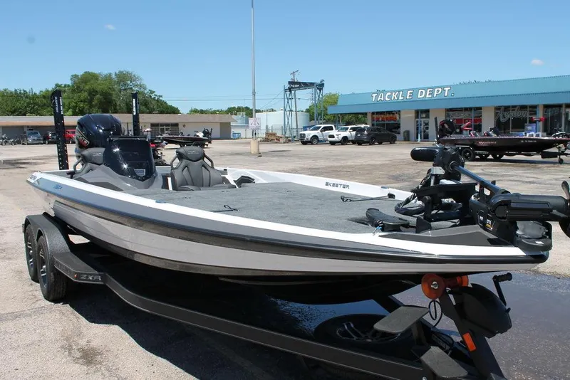 Slide: The Image of 2025 Skeeter ZXR21 boat on trailer outside tackle shop. - 8