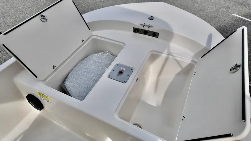 Slide: The Image of 2025 Carolina Skiff 178 JLS CC boat storage compartments open, showcasing interior space. - 7