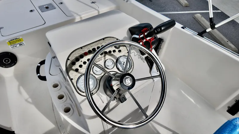 Slide: The Image of 2025 Carolina Skiff 178 JLS CC boat console with steering wheel and gauges. - 8