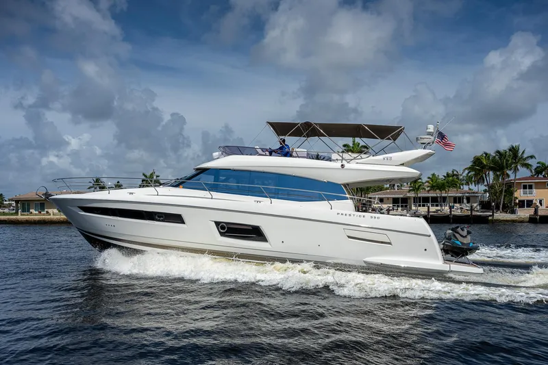 Slide: The Image of 2014 Prestige 550 yacht cruising on water under a cloudy sky. - 22