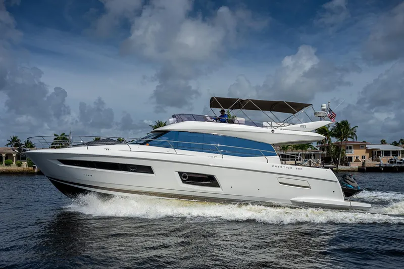 Slide: The Image of 2014 Prestige 550 yacht cruising on a sunny day with a cloudy sky backdrop. - 23