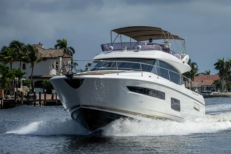 Slide: The Image of Luxury 2014 Prestige 550 yacht cruising on a scenic waterway. - 28