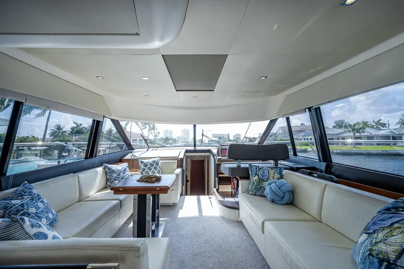 Slide: The Image of Luxurious interior of a 2014 Prestige 550 yacht with elegant seating and panoramic windows. - 44
