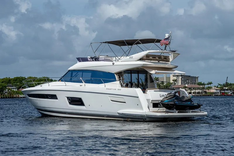 Slide: The Image of 2014 Prestige 550 yacht on water, featuring sleek design and luxury amenities. - 7