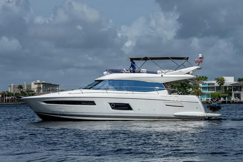 Slide: The Image of Luxury 2014 Prestige 550 yacht cruising on a calm waterway under cloudy skies. - 9