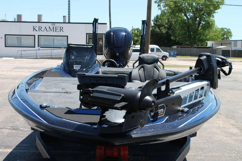 Slide: The Image of 2025 Skeeter ZXR20 boat with advanced motor, parked outdoors near Kramer building. - 4