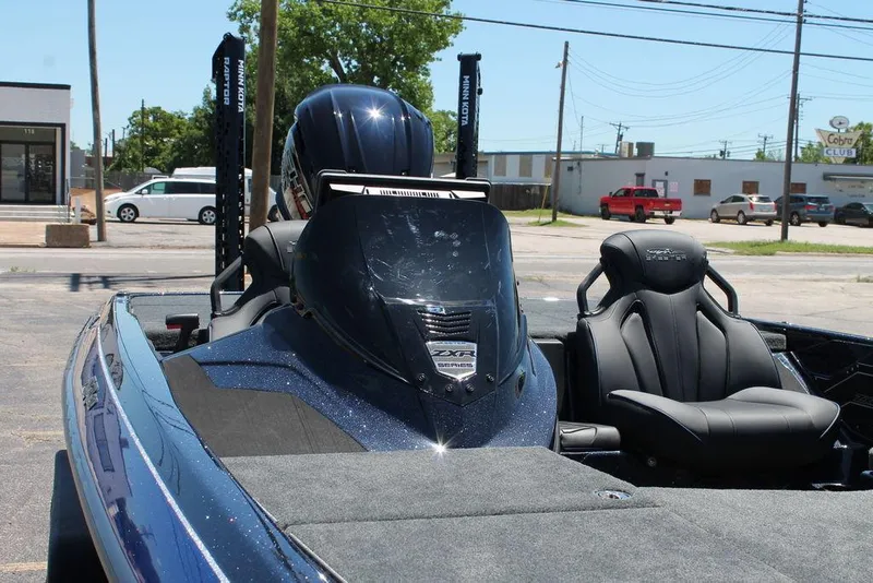 Slide: The Image of 2025 Skeeter ZXR20 boat with sleek design and comfortable seating in a parking lot. - 9