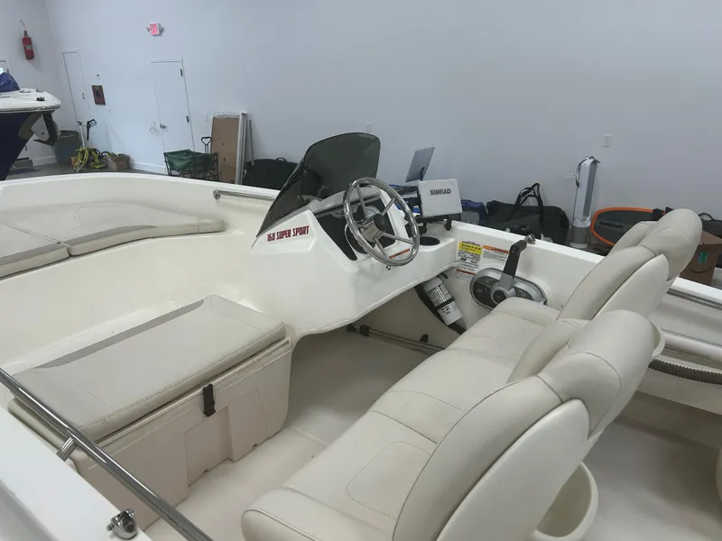 Slide: The Image of 2020 Boston Whaler 160 Super Sport interior with steering console and seating. - 5