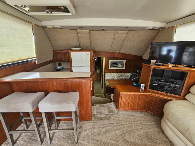 Slide: The Image of Interior of 1991 Viking 45 Convertible yacht with bar, seating, and entertainment area. - 10