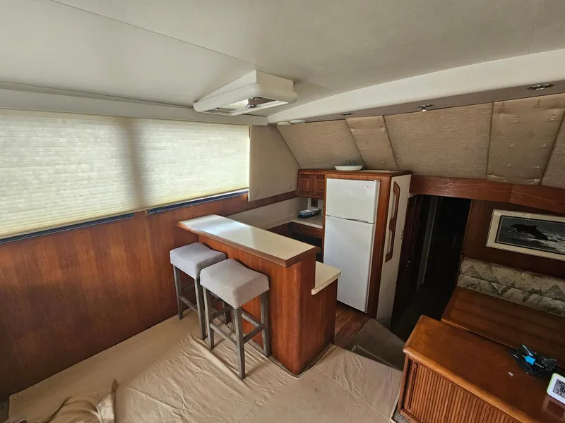 Slide: The Image of Interior of 1991 Viking 45 Convertible yacht with bar stools and kitchenette. - 11