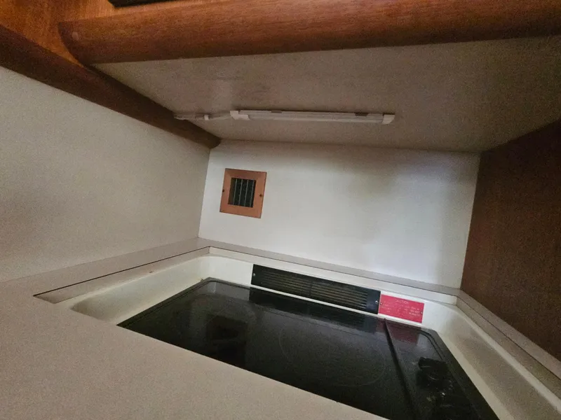 Slide: The Image of 1991 Viking 45 Convertible kitchen area with stove and wooden cabinetry. - 15